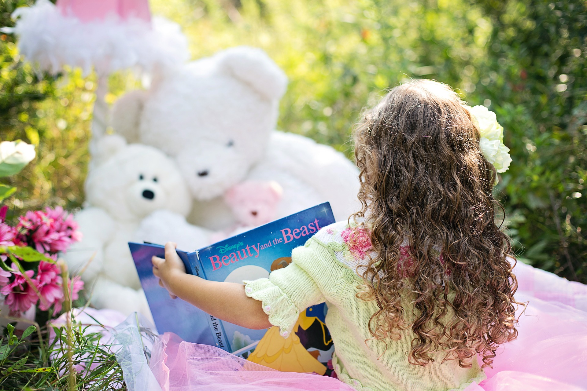 girl reads to stuffed animals